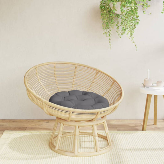 Coussin rond anthracite présenté sur un siège dans une ambiance décorative, siège non inclus.