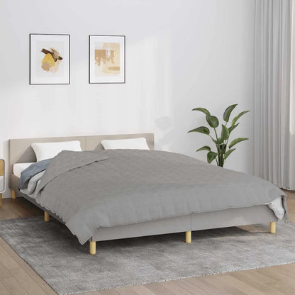 Couverture Lestée 15kg grise présentée sur un lit