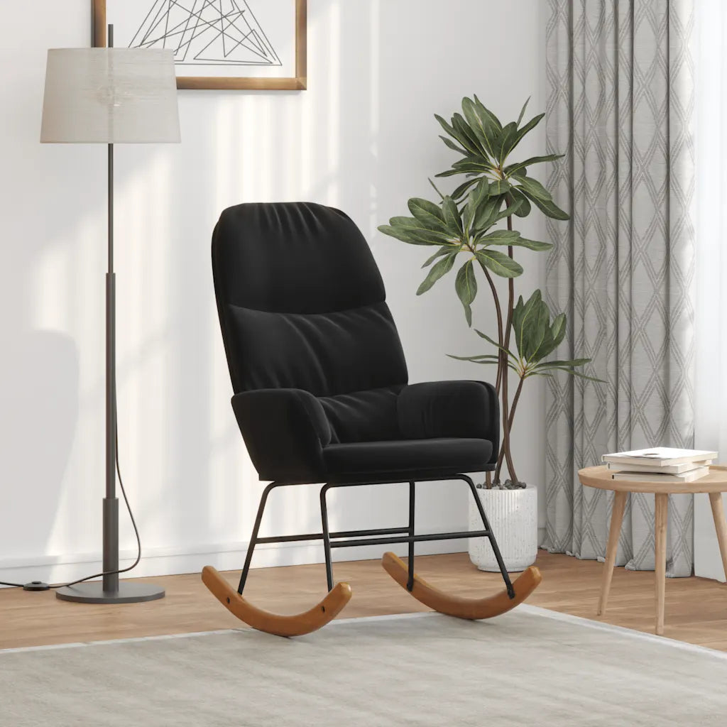 Petit fauteuil à bascule en velours noir vu de trois quarts, avec accoudoirs et patins courbés.