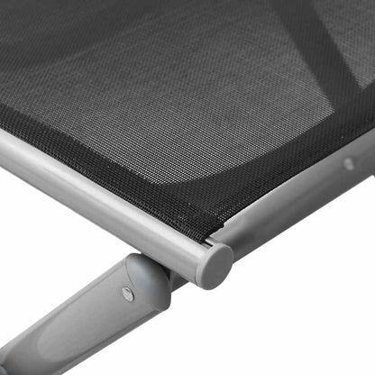 Repose-pieds pliable noir et argenté, détail de la surface en textilène
