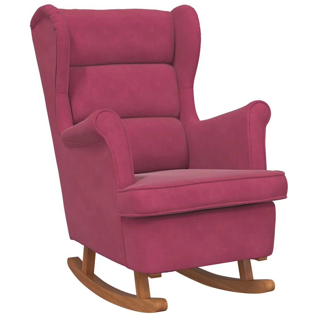Rocking chair rouge vin en velours, vu de trois quarts sur fond blanc, avec patins en bois.