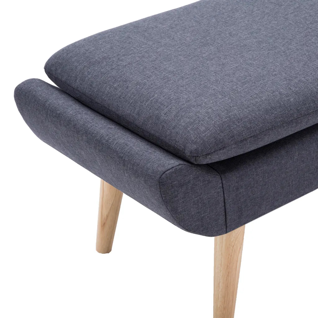 Un Tabouret Repose Pieds avec un revêtement tissu gris.